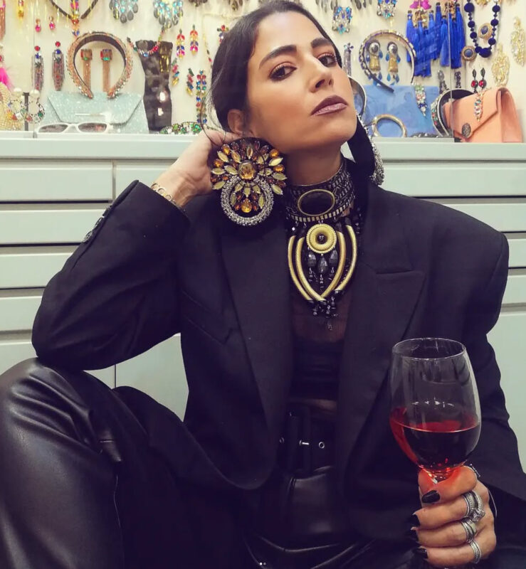 Έλενα με υπερβολικά κοσμήματα, μαύρο blazer look, μεγάλο statement σκουλαρίκι και dramatic choker στο κατάστημα Double Trouble.